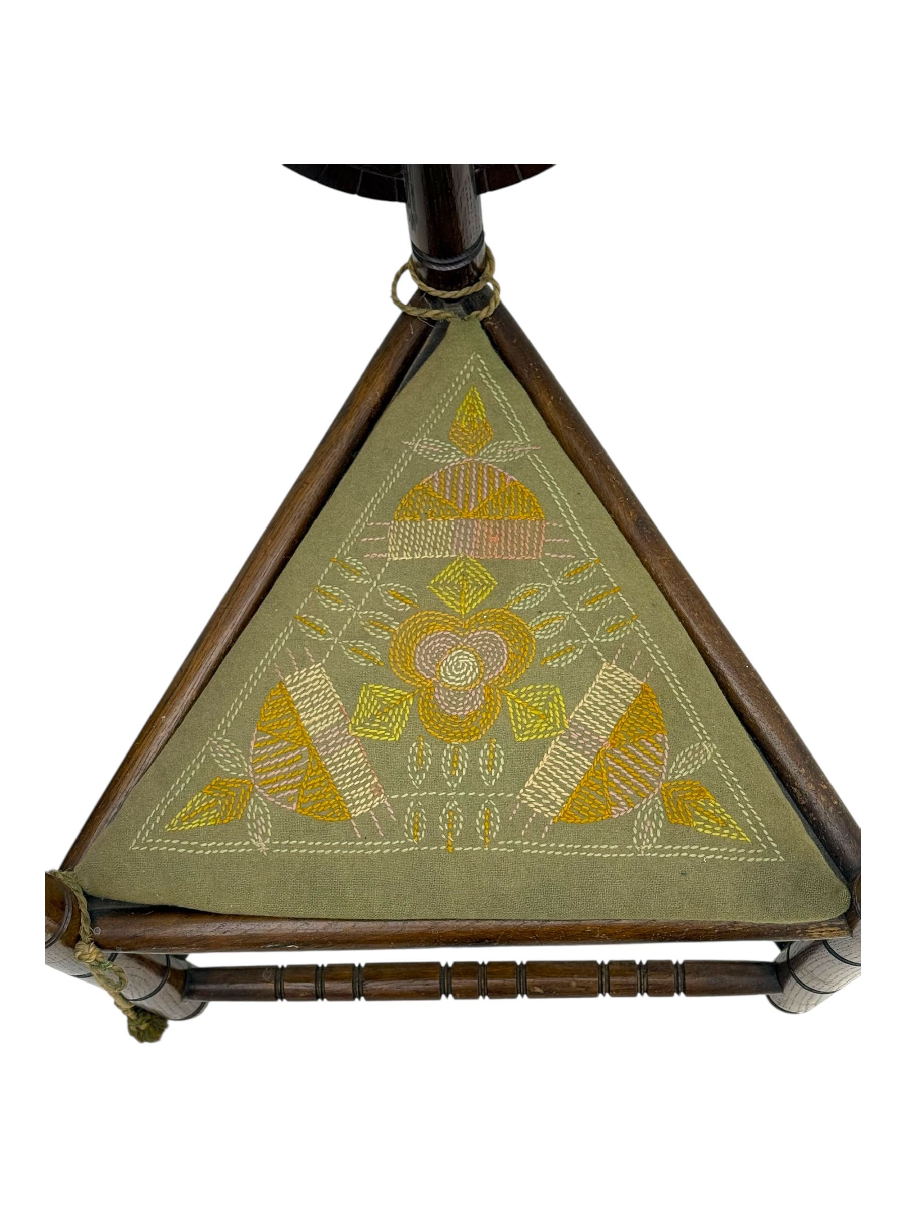 19th century swedish monk's chair, the oak frame with triangular seat and sloped arms, the backrest carved with geometric chipwork and a central pierced medallion 