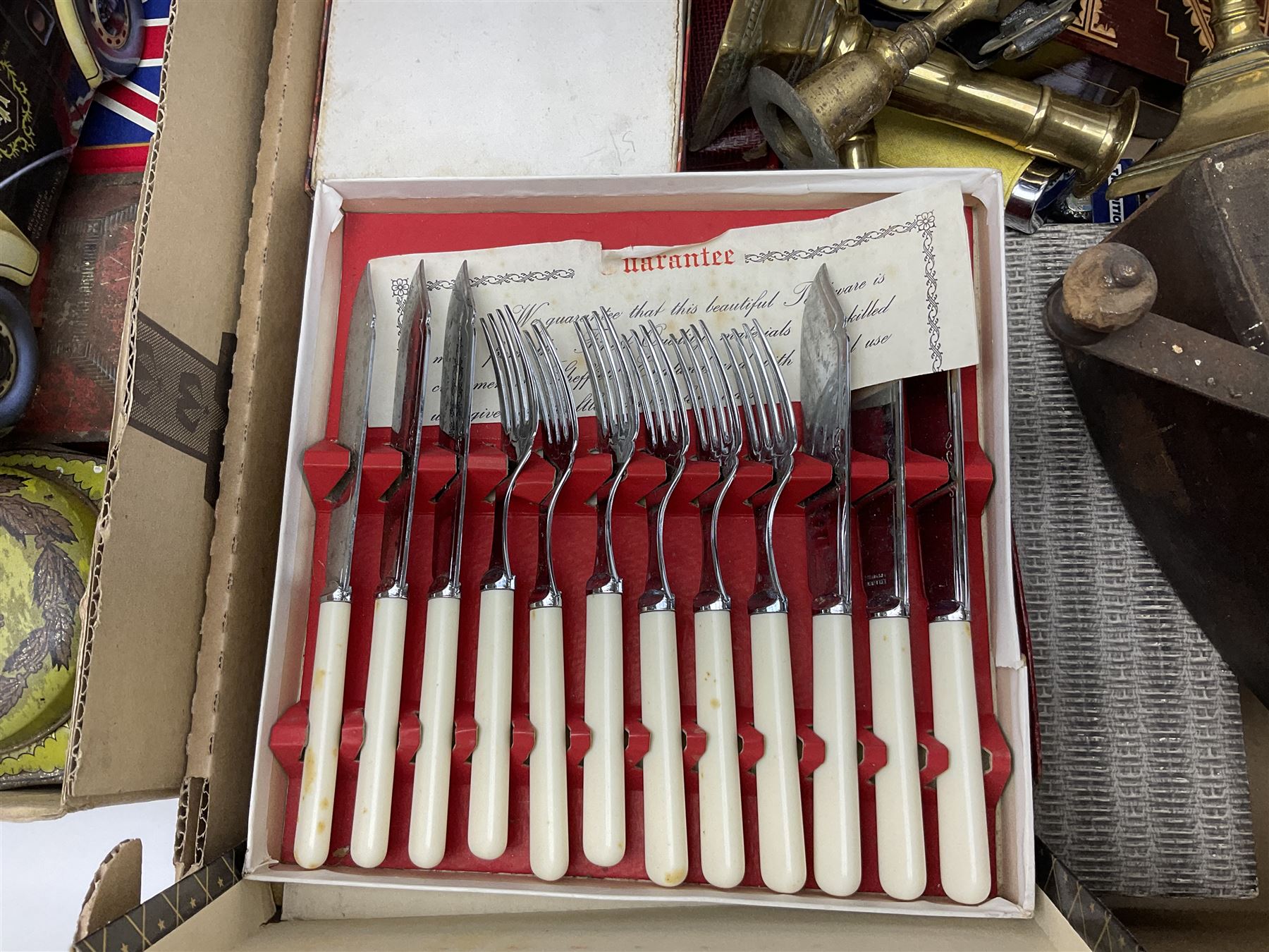 Collection of silver plated cased cutlery including part canteens and butter knives, together with other metal ware including J&J Siddons iron, horse brasses and a copper kettle, 1970s children's annuals including Beano, two handbags and three suitcases, vintage tins etc, in four boxes 