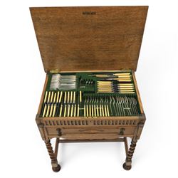 Early 20th century oak cased canteen on barleytwist stand, hinged top with fitted baized lined interior, above a drawer fitted for cutlery