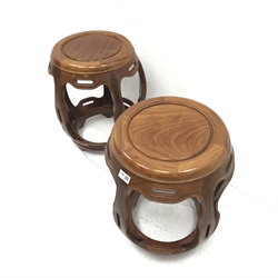 Pair Chinese rosewood circular barrel shaped occasional tables, five shaped supports joined by stretchers, D42cm, H46cm