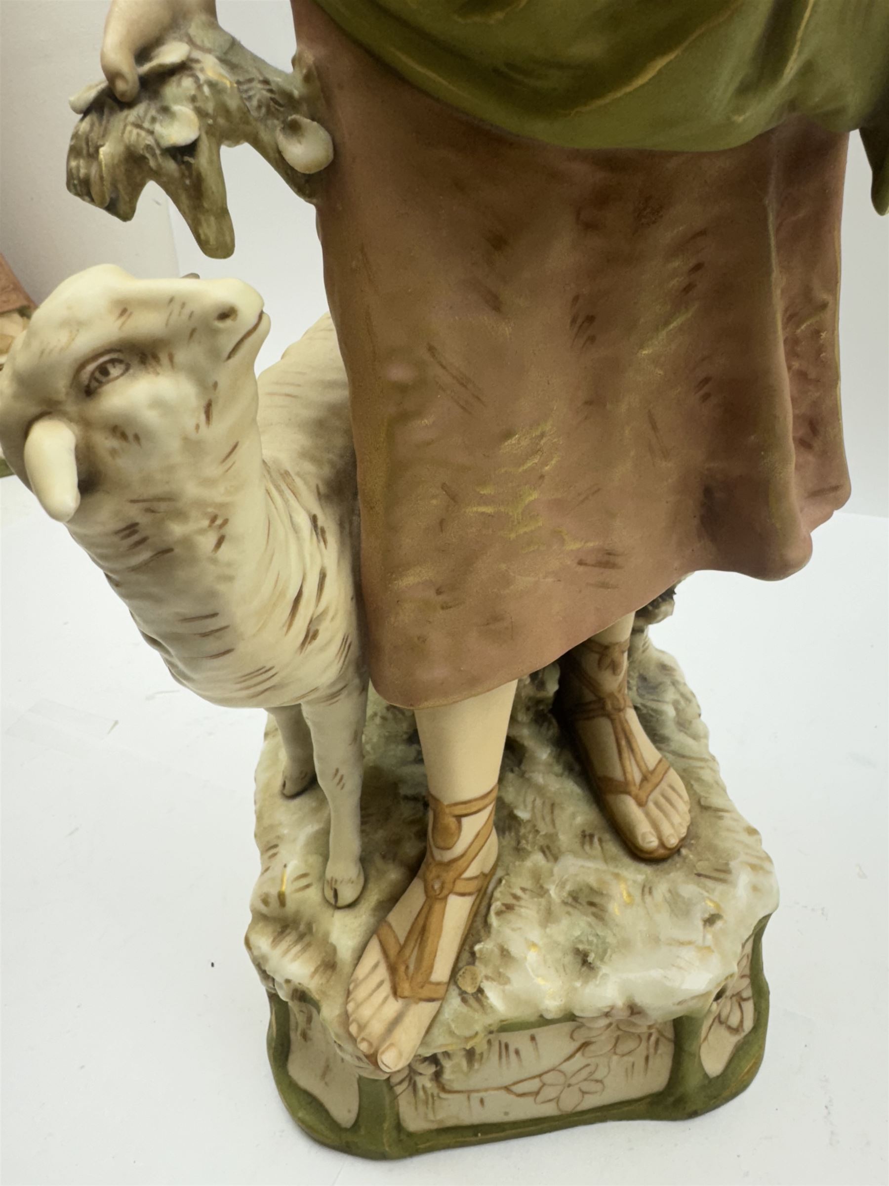 Pair of Royal Dux figures, no. 1115, modelled as a shepherd with a goat by his side and a shepherdess feeding a lamb, each wearing flowing green and pink robes with gilt detailing, with pink triangle mark beneath, H51cm