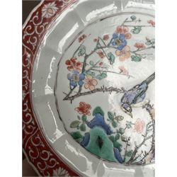 Chinese Kangxi famille verte plate, decorated with a bird perched upon a blossoming branch, within an iron red foliate border, D22cm
