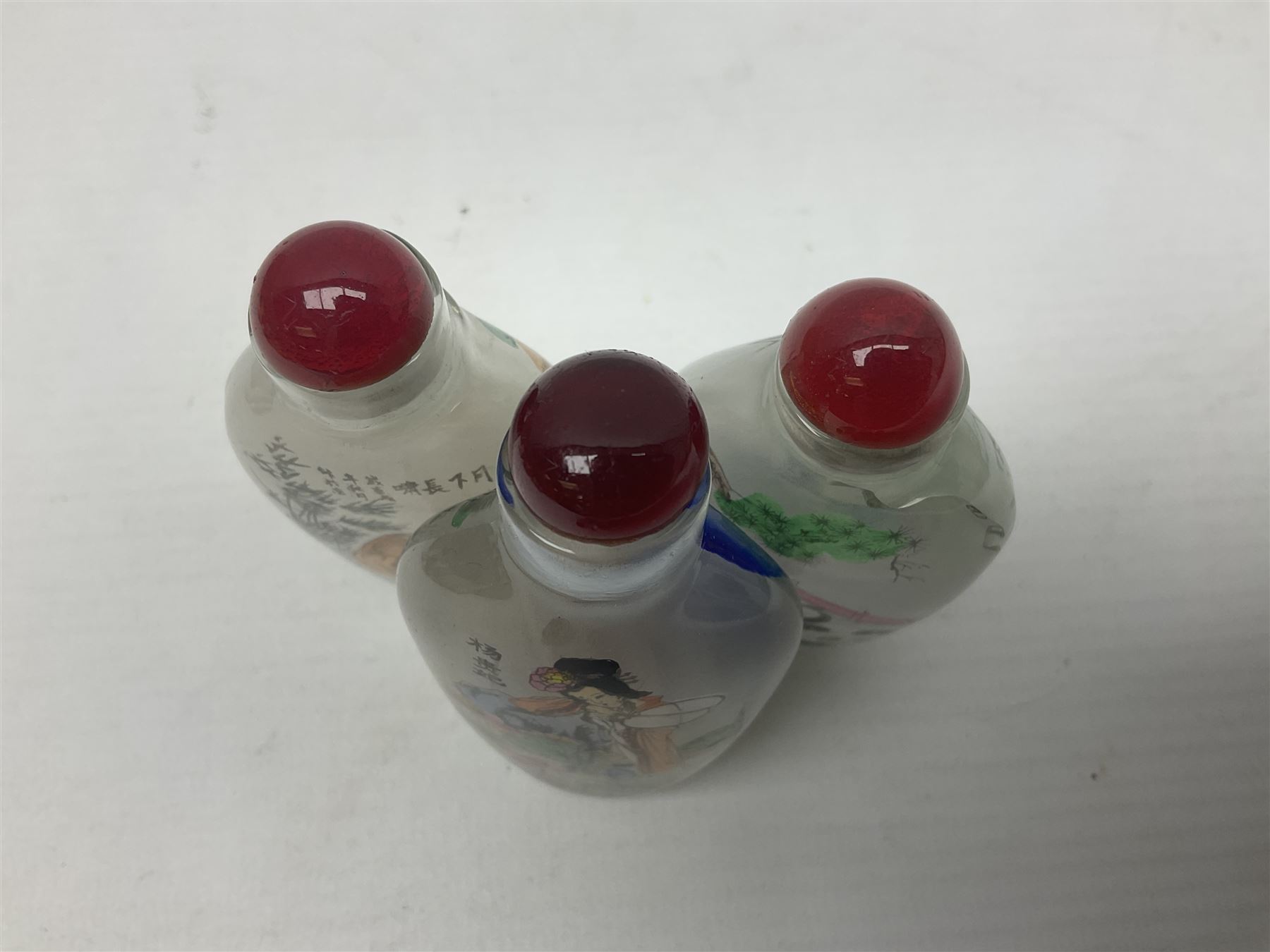 Seven Chinese glass snuff bottles painted with figures and animals, together with three wood mounted bone examples