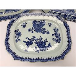 Two late 18th/early 19th century Chinese export blue and white platters and dish, each of rectangular form with canted or shaped corners, two examples decorated with waterside landscapes, the third with blossoming flowers, largest example W40cm