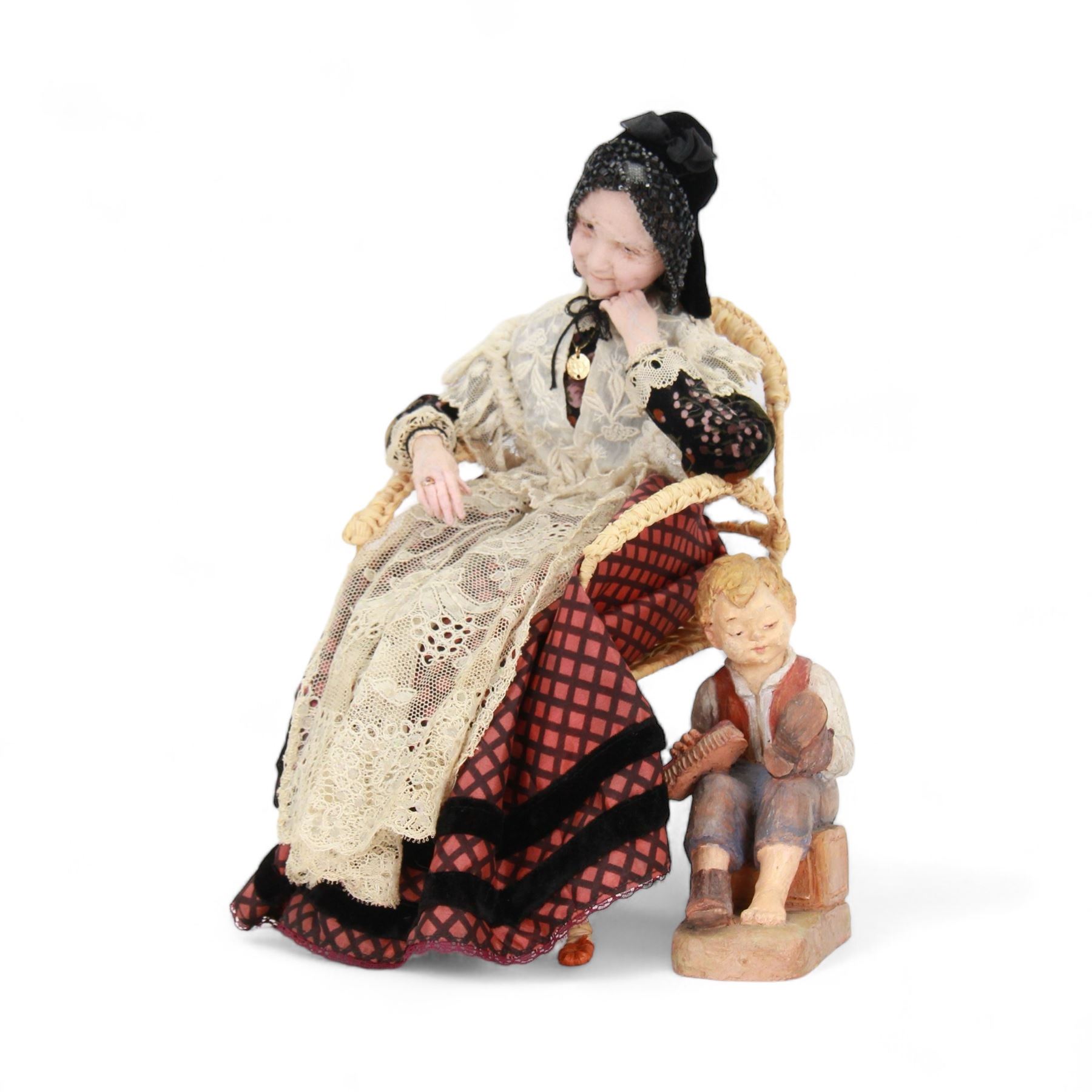 Anna Meszaros (Hungarian 1905-1998): 'My Great Granny', handmade needlework figurine, together with small plaster cast of a young boy by the same artist, granny H30cm
Auctioneer's Note: Anna Meszaros came to England from her native Hungary in 1959 to marry an English businessman she met while demonstrating her art at the 1958 Brussels Exhibition. Shortly before she left for England she was awarded the title of Folk Artist Master by the Hungarian Government. Anna was a gifted painter of mainly portraits and sculptress before starting to make her figurines which are completely hand made and unique, each with a character and expression of its own. The hands, feet and face are sculptured by layering the material and pulling the features into place with needle and thread. She died in Hull in 1998