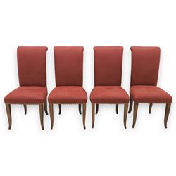 Contemporary circular painted dining table and four red upholstered chairs, table with distressed finish in black with quatriform base and bronze painted edges, chairs with 