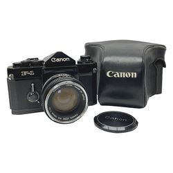 Canon F1n camera body, serial no. 572972, with 'Canon FD 50mm 1:1.4' lens, serial no. 246665, with leather case 