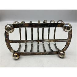 Silver plate seven bar toast rack, of curved form with central ring handle, upon bun feet, H13cm 
