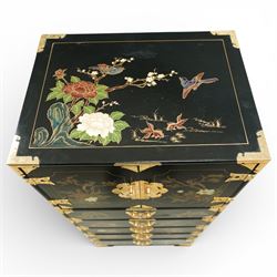 Japanese Shibayama style black lacquered curio chest, cupboard doors enclosing four short over two long fitted drawers, decorated in gilt with birds, flowers and landscape scenes, raised on gilt mounted bracket feet