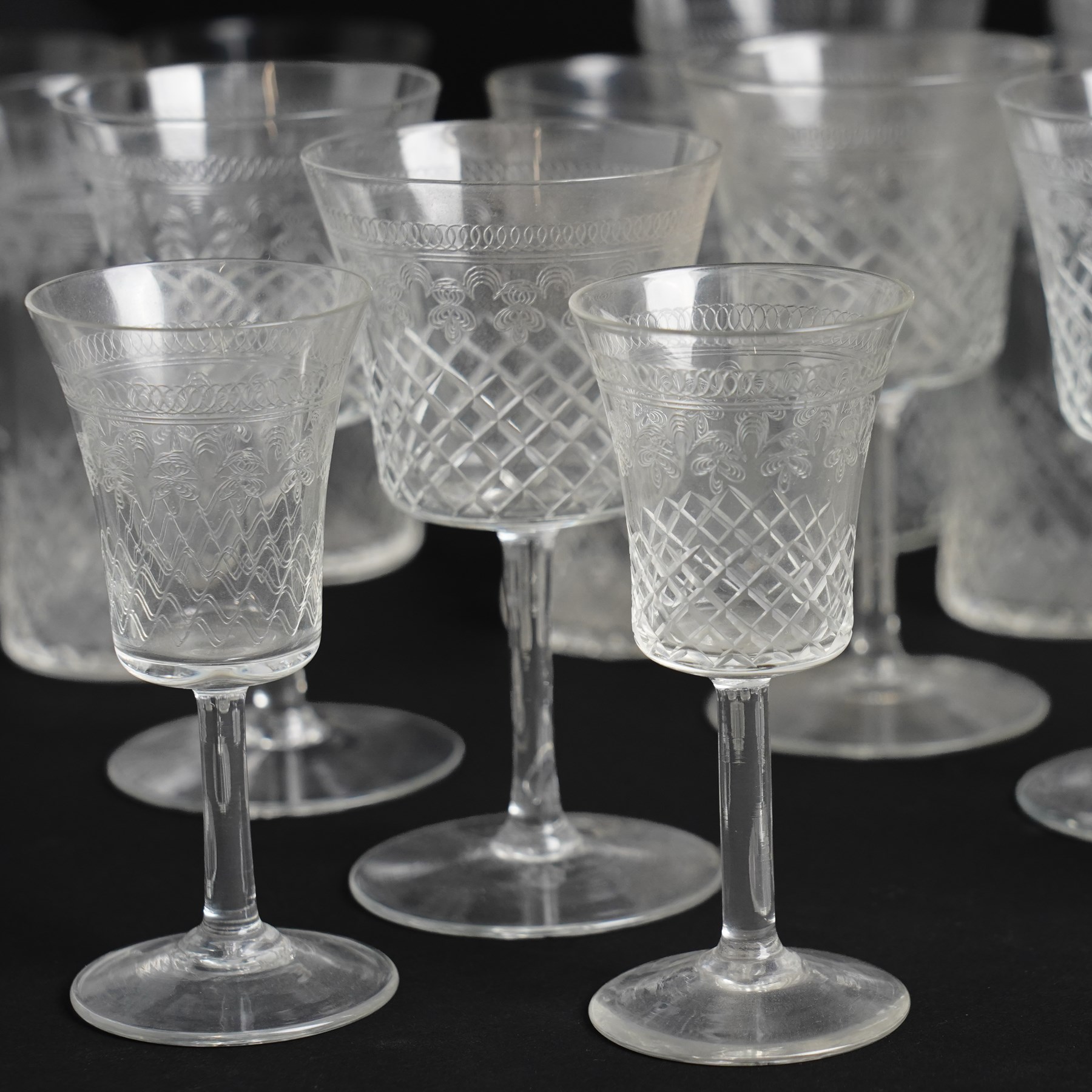 Suite of early 20th century cut and etched table glass comprising nine tumblers, ten smaller tumblers, eleven small wine glasses, six sherry glasses and water jug together with four other sherry glasses