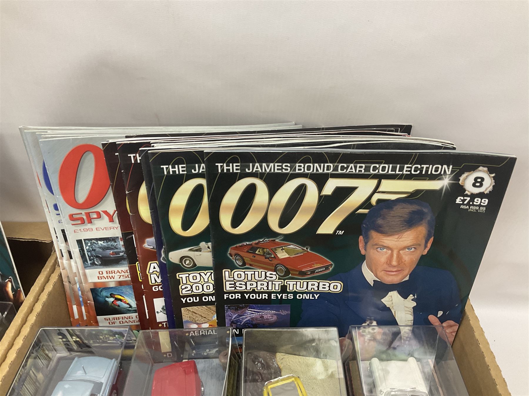 Fabbri James Bond Collection - over one hundred and ten die-cast models in perspex display cases as issued periodically; and a quantity of associated magazines and trading cards, in five boxes