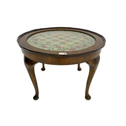 Early 20th century walnut occasional table, with needlework panel and glass top, on cabriole supports