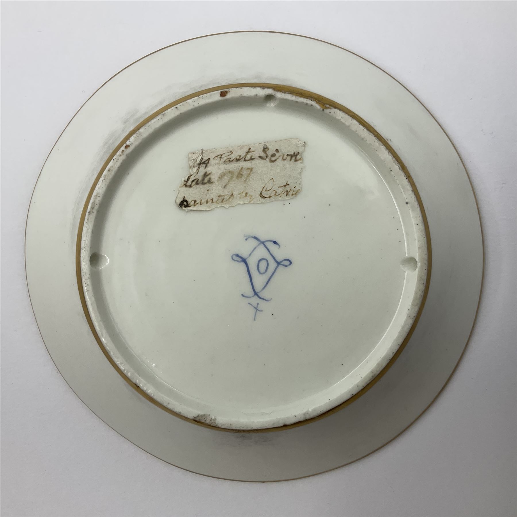 Sèvres soft paste porcelain coffee can and saucer with date code for 1767, painted with floral and laurel leaf garlands within blue scalloped and gilt borders, interlaced LL monogram enclosing the date letter O above painters mark for Catrice, coffee can H7.5cm, saucer D15cm