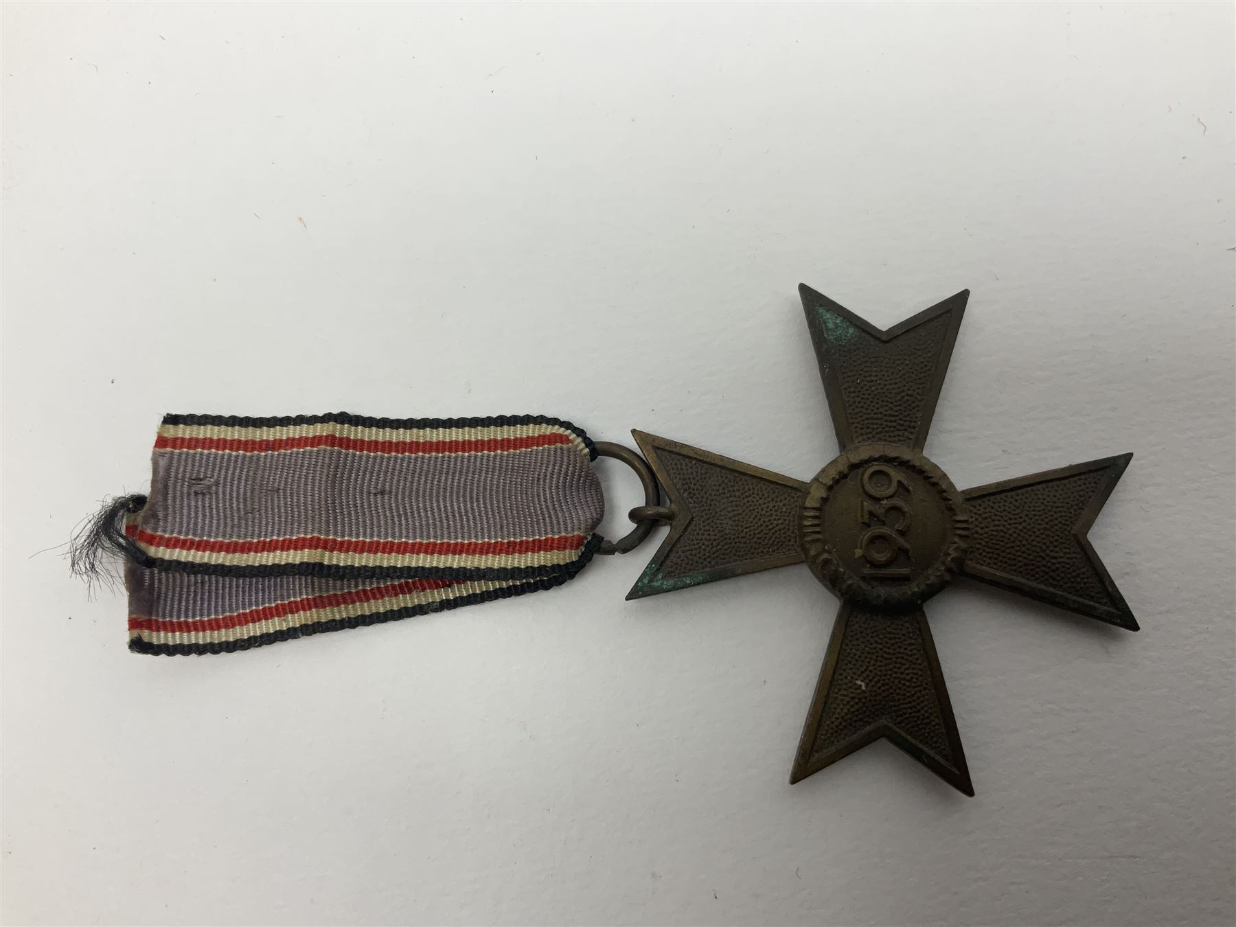 Five WW2 German medals/badges -German Defences West Wall Medal, War merit Cross, Red Cross Decoration, RAD tinnie brooch and Adolf Hitler 1934 medallion (5)