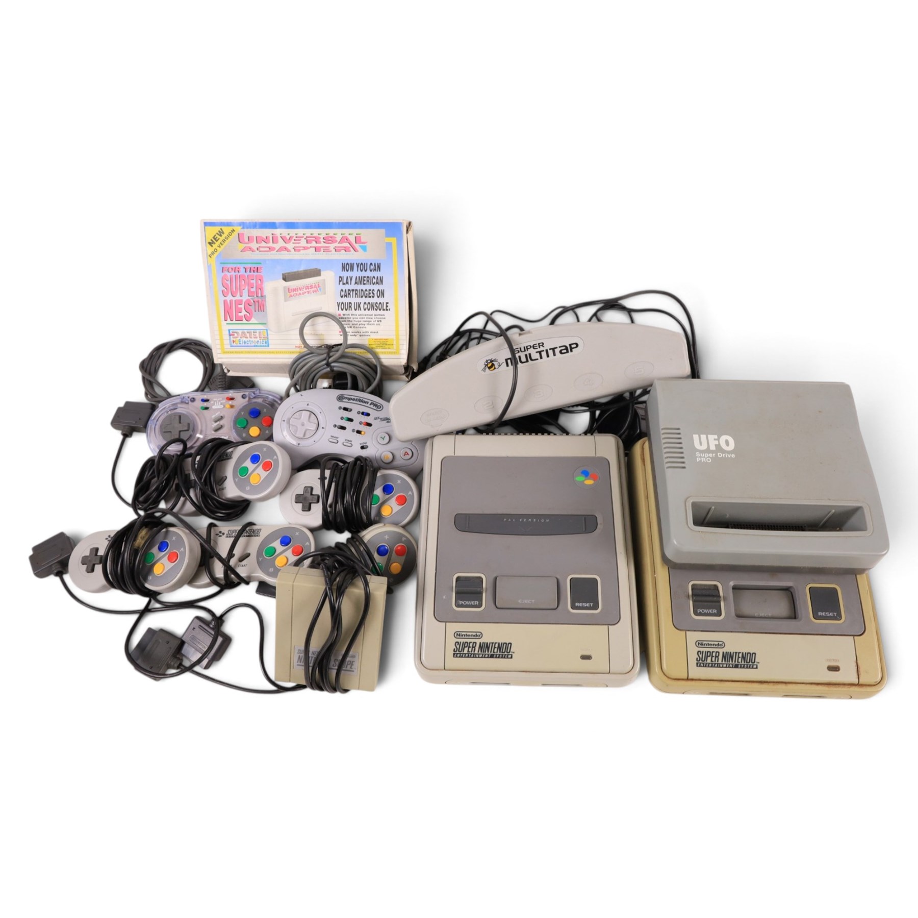 Two Super Nintendo Entertainment System consoles, accessories to include Super Multitap, UFO Super Drive Pro, Universal Adapter, Game Genie, Scope 6 accessories (Scope not present), seven controllers including one Competition Pro and a SN Pro Pad and fifteen SNES games comprising eleven boxed and four unboxed examples, titles to include Dragon The Bruce Lee Story, Street Fighter II Turbo x2 (one unboxed), Royal Rumble, Super Mario Kart, Radical Psycho Machine Racing, Super Bomberman, Super Bomberman 2, Protector Alien Rebels, Double Dragon, Goof Troop, WWE Raw Wrestling, Tetris Attack, Donkey Kong Country and Starwing