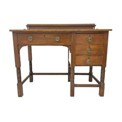 Early 20th century oak writing desk, raised back over rectangular top with inset leather writing surface, fitted with four drawers, raised on ring turned supports