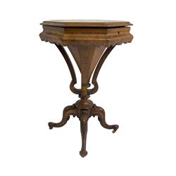 Victorian walnut work or sewing table, octagonal form with hinged lid, upholstered and fitted interior, on four plain and shaped supports with central trumpet, on four splayed and foliate carved supports