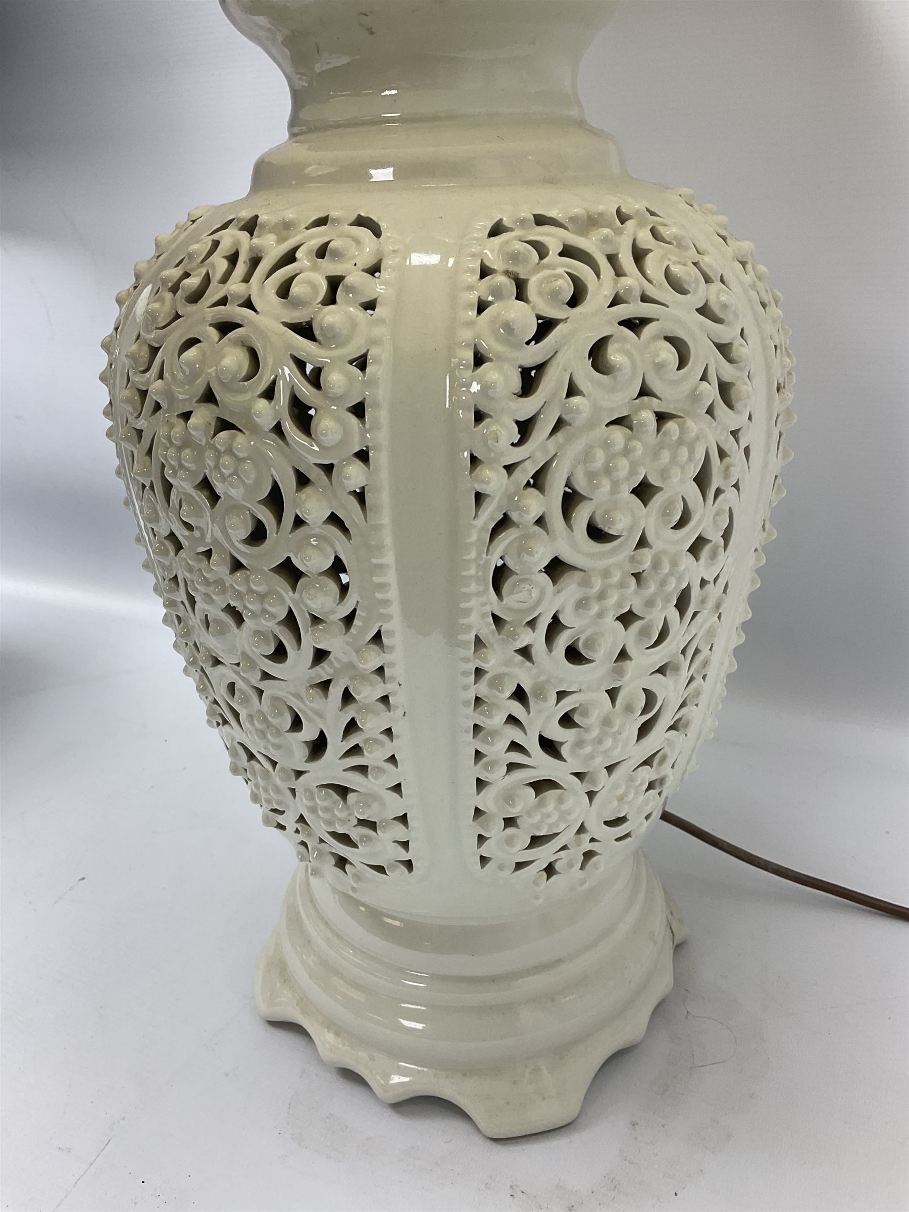 Modern pierced oriental white ceramic vase shaped table lamp, together with a blue and white baluster shaped example decorated with figures upon elephants, both with shades, tallest H83cm incl shade