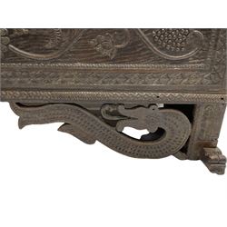 George III oak blanket box or kist, moulded rectangular top over hinged fall-front, with arcade frieze and central flower head with extending trailing branch and foliage, within a border carved with flower heads, initialled 'C.E R.T', fitted with wrought metal carrying handles, scaled serpent carved lower brackets, on sledge feet