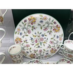 Minton Haddon Hall pattern tea and dinner wares, including basket dish, two covered tureens, six dinner plates, eight dessert plates, twelve tea plates, six soup bowls, six cereal bowls, teapot, coffee pot, milk jug, covered sucrier twelve tea cups and saucers, six mugs, footed bon bon dish, pair of candlestick holders, cake knife and slice etc (81)