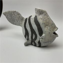 A studio pottery model of a fish, with Snowden pottery Christopher John stamped beneath, H17cm together with a large studio pottery bowl with painted fish design on a dark blue ground, D31.5cm. 