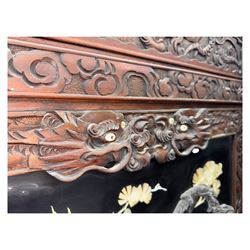 Meiji period (1868–1912), Shibayama lacquer carved hardwood two-fold screen inlaid with mother-of-pearl, bone, and ivory, decorated on one side in high relief and inlaid in a  Shibayama manner with oriental storks flying below flowering branches,  the reverse lacquer panels depicting flowering cherry trees. This item has been registered for sale under section 10 of the APHA Ivory Act.
