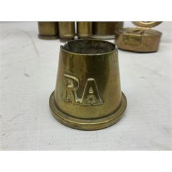 Reproduction brass pocket sextant, in circular drum shaped case, engraved 'Nauticalia' 99076  D9cm; trench art brass ashtray of conical form applied with the letters R.A.; an all brass model field cannon on carriage; and four graduated brass WW1/WW2 shell cases (7)