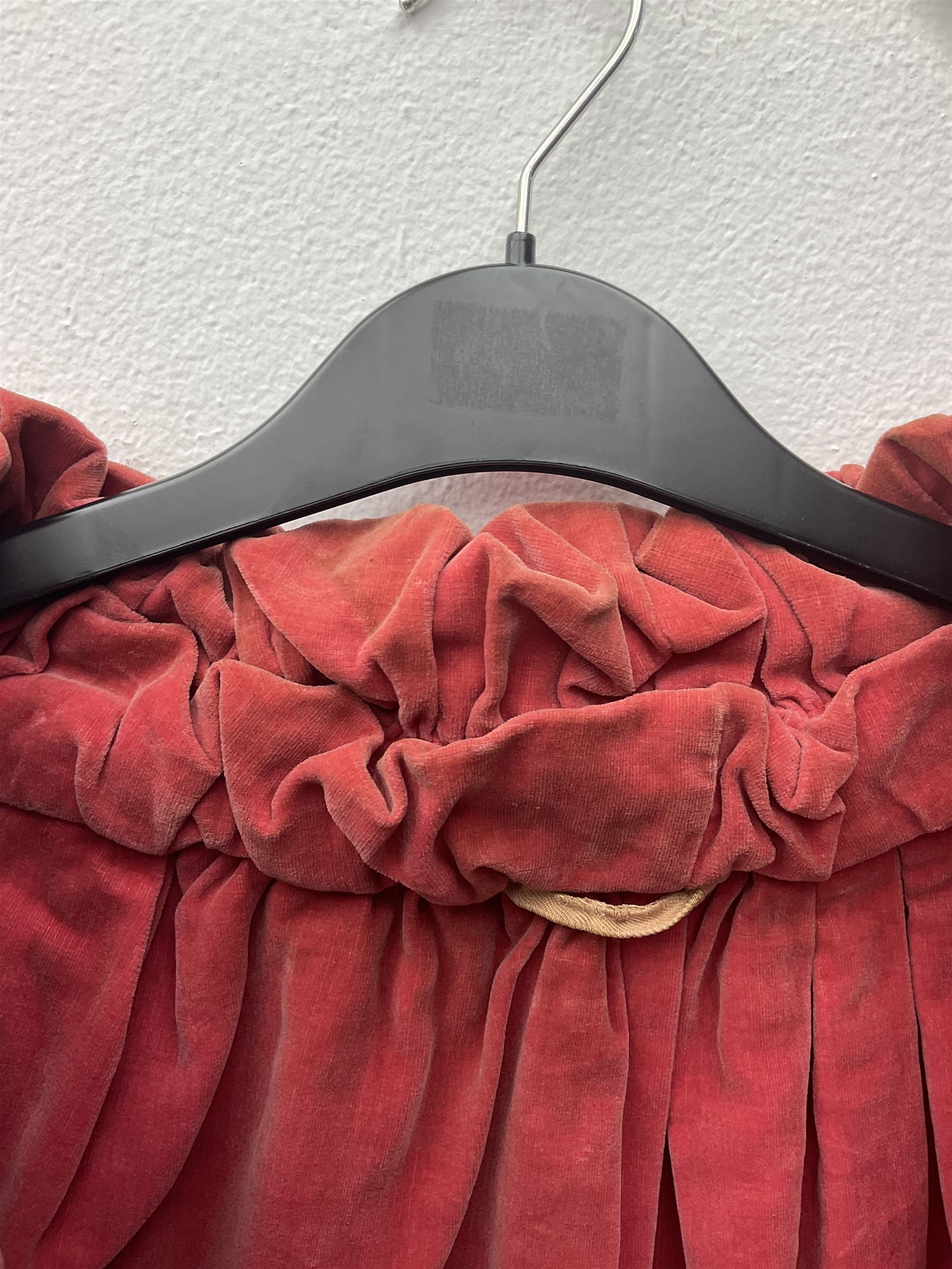 Full length 1930's childs black velvet cape, with ruched collar and red velvet lining, with a single button neck fastening 