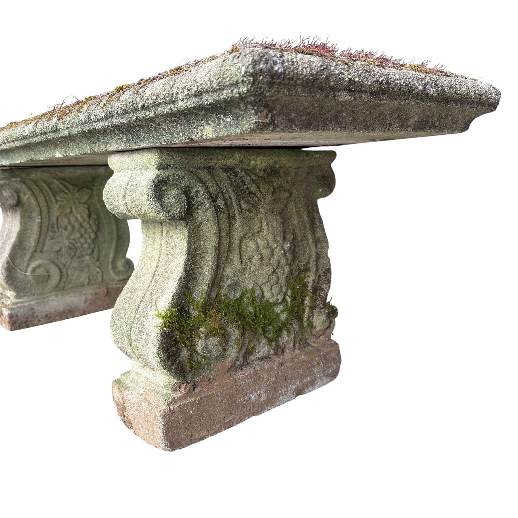 Weathered cast stone three piece bench, the rectangular seat with moulded edge, raised on Neoclassical style end supports with S-scrolls and fruiting grapevines, on rectangular bases
