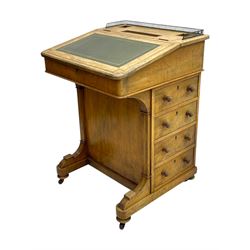 Early 19th century burr walnut Davenport desk, sloped leather-inset writing surface with brass gallery, fitted with an inkwell compartment and pen slot, four drawers to one side, raised on scrolled supports terminating in castors