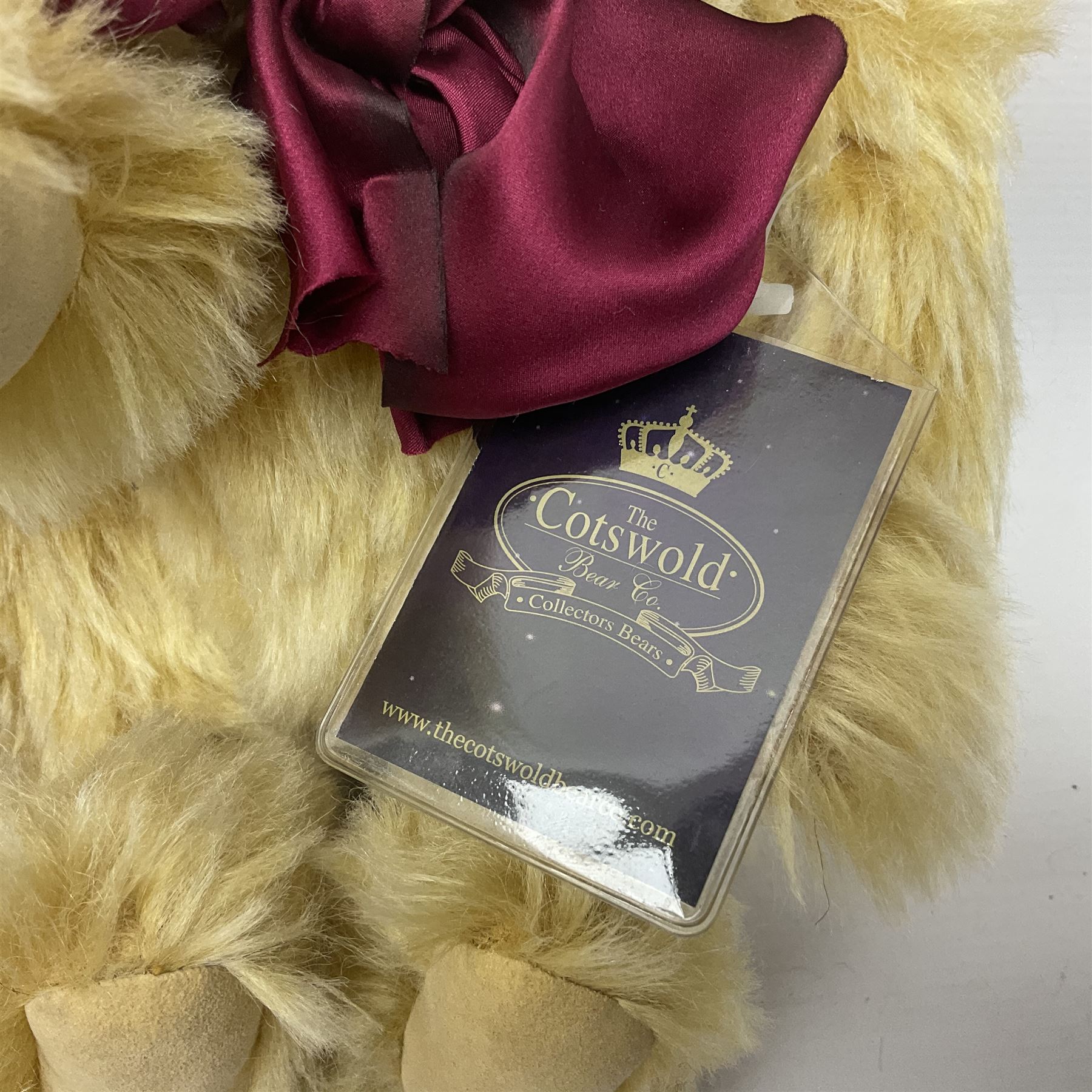 The Cotswold Bear Company - two teddy bears from ‘The Flower Collection’ comprising ‘Mayflower’ no.99/100, blonde mohair with dark pink flower crown and bow, H33cm; ‘Phoenix’ no. 99/100, blonde mohair with white and red rose flower crown and bow, H28cm; both with original labels and purchase receipt (2)