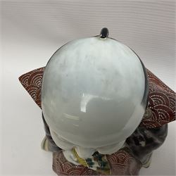 Japanese Fukusuke good fortune figure, modelled as a kneeling male figure holding a fan, dressed in traditional Samurai robes, H15.5cm