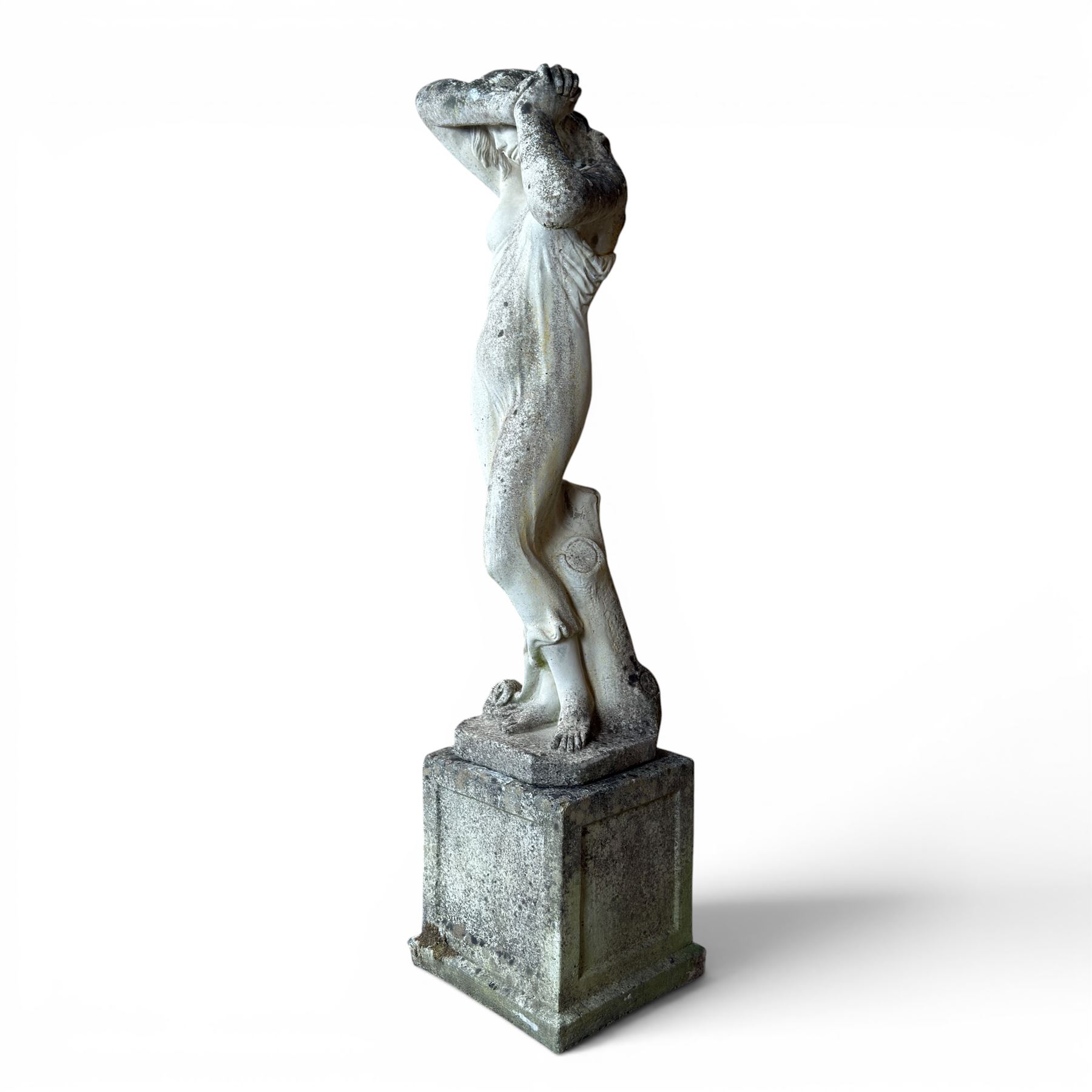 Weathered cast stone garden statue of a 'Shy Maiden', raised on square plinth base