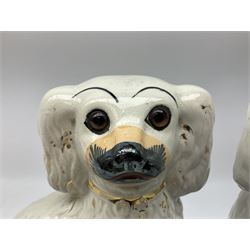 Pair of Victorian Staffordshire white glazed spaniels with glass eyes, H25cm  
