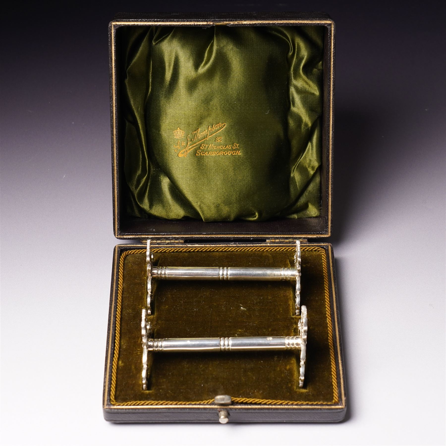 Pair of late Victorian silver knife rests with scroll moulded decoration Sheffield 1898 Maker Lee & Wigfull in original leather box for A & J Thompson, Scarborough 