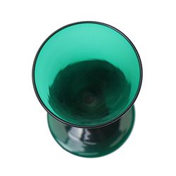 Five green wine glasses of early 19th century design with conical bowls and double knop stems on a circular foot, with pontil marks, pair of green wine glasses with chamfered stems together with an Asprey catalogue of green glass 1740-1840 and two pieces of glass fruit and leaves