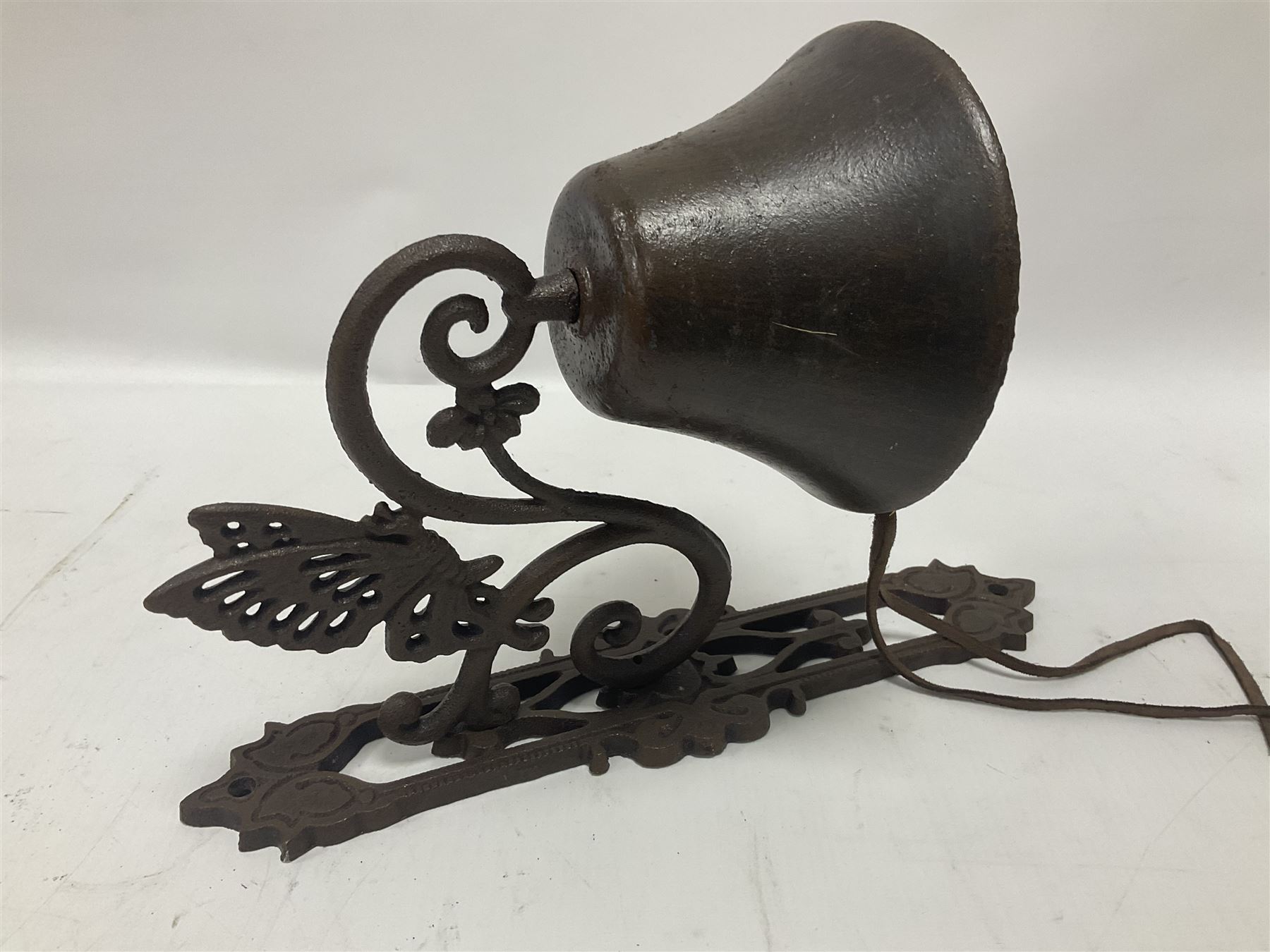 Cast iron exterior hanging garden bell with decorative butterfly bracket