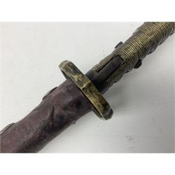 Copy of a WWII Japanese NCO sword, the 65cm slightly curving blade stamped with pseudo Japanese characters and cast brass simulated cord bound grip; in officer's leather bound field scabbard L97cm overall