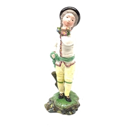 A 19th century Höchst porcelain figure, modelled as a young boy holding a Garland of flowers, H14cm, (a/f, restoration to hat and legs and base). 