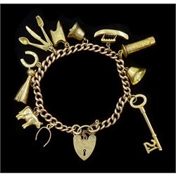  Gold curb link chain bracelet, with heart locket clasp and eleven gold charms including cow, cat, post box and cutlery, all 9ct