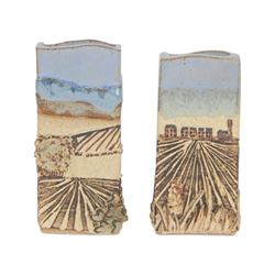 Robin Gough; two studio pottery vases of rectangular chimney vase, each decorated in relief with villages, H15cm 