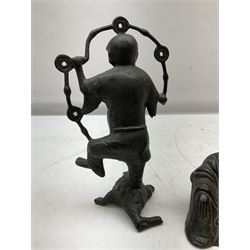 Cast iron figure of Liu Hai, the Chinese God of Wealth modelled standing with one foot upon mythical three-legged chánchú toad and holding a string of Chinese coins, H21cm, together with a cast iron figure of a seated laughing Buddha