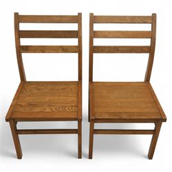 Treske of Thirsk - solid oak refectory dining suite, rectangular top with chamfered edge over trestle base united by a central stretcher, together with six matching slat back dining chairs, including two carvers, with panelled seats and square legs united by stretchers (H 87cm, W 62cm, D 57cm)