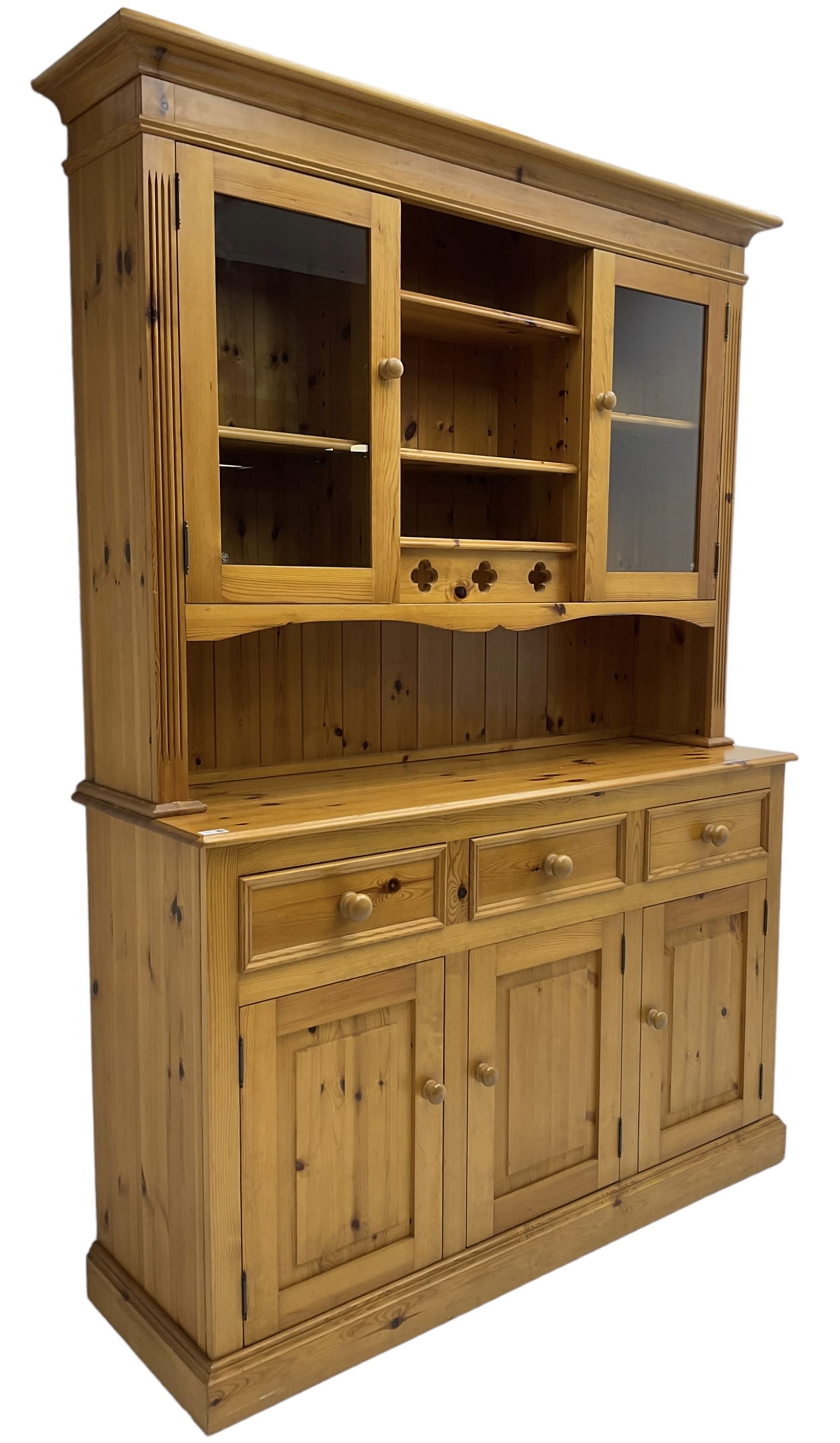 Traditional pine dresser, the rack fitted with two shelves flanked by glazed cupboards, the base with three drawers over three panelled cupboards