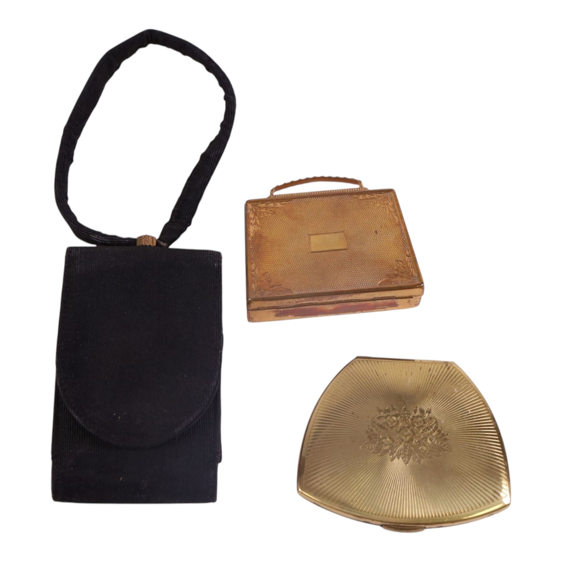 Six powder compacts, including Kigu Bon Voyage example modelled as a suitcase with travel stickers, Volupte compact, three Mascot compacts, including musical handbag and a New York Vanity