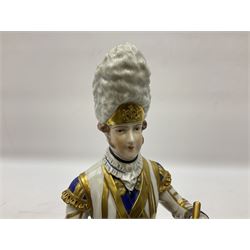 Dresden Drummer of the 3rd Guards figure, modelled playing drum standing to attention, his dress and headwear detailed with gilt, raised upon green and brown square plinth base, with printed marks beneath, H27cm