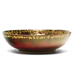 Four pieces of Fielding's Devon Lustrine, comprising a small pair of sleeve vases, H15cm; a bowl and vase, each decorated with butterflies and leaves in gilt on a red ground, printed marks beneath (4)