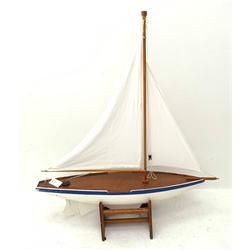Pond yacht with white painted planked wooden hull, weighted metal keel and two sails L92cm H106cm, on wooden stand