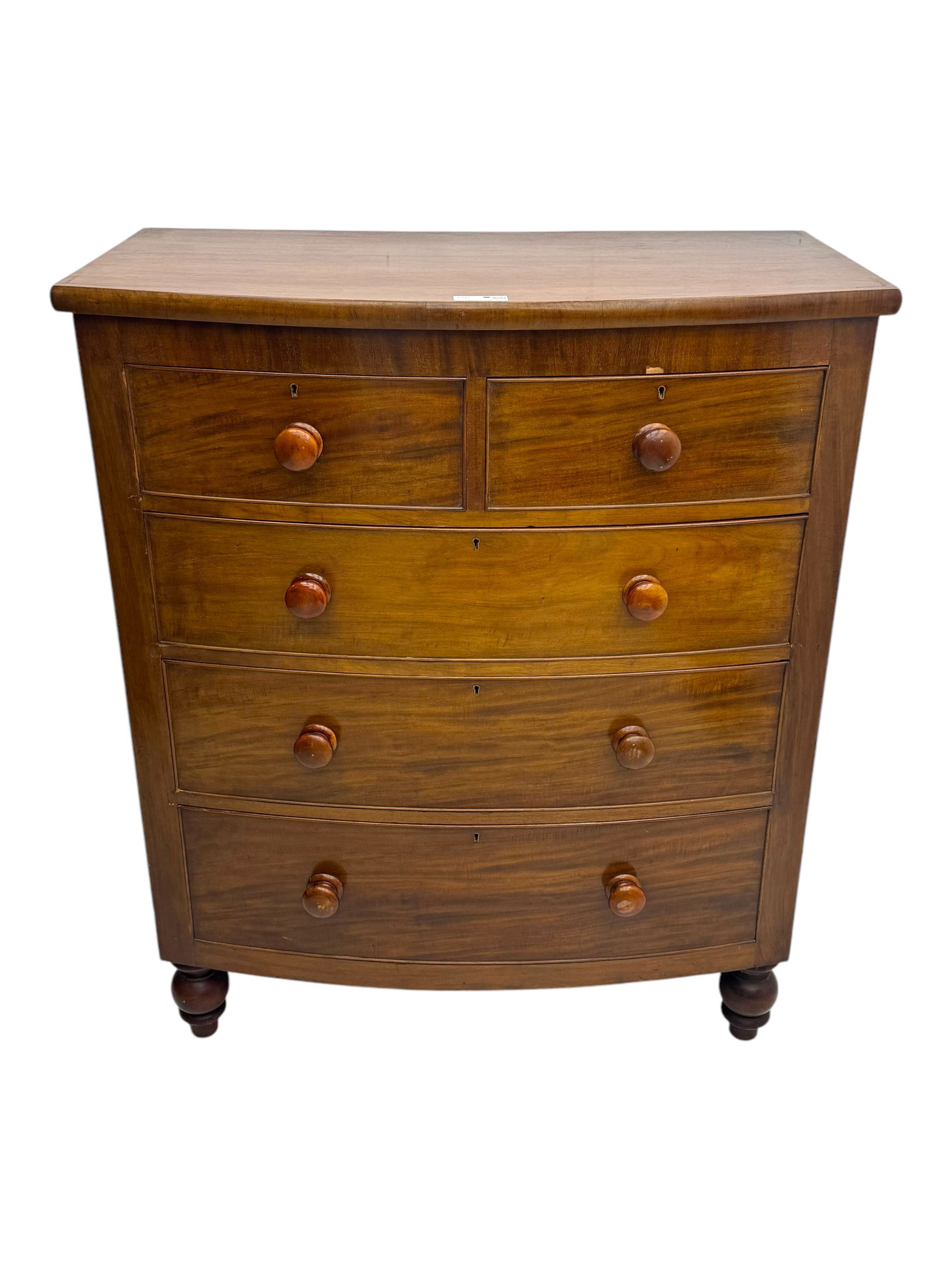 Victorian mahogany bow-fronted chest, fitted with two short over three long graduated cockbeaded drawers, on turned bun supports