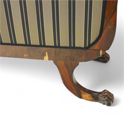 Regency brass inlaid rosewood chaise lounge or settee, shaped back over rolled head and foot, upholstered in black and gold striped fabric with rectangular squab cushion and bolster cushion, the rolled terminals carved with acanthus leaf roundels, lower rectangular foliate carved panels, on out splayed supports with paw carved feet 
